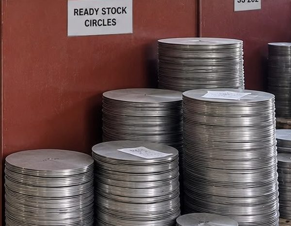 Stacked stainless steel circles ready for utensil pressing
